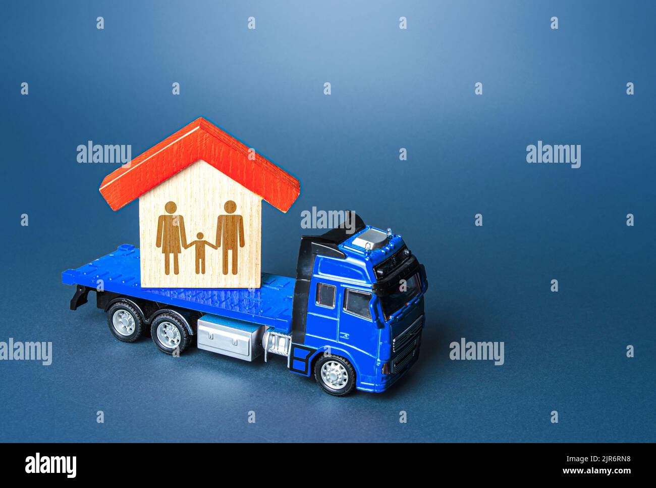 The truck transports the house with the family. Home moving transport company. Relocation for work. Mobility and flexibility of workers. Migration of Stock Photo