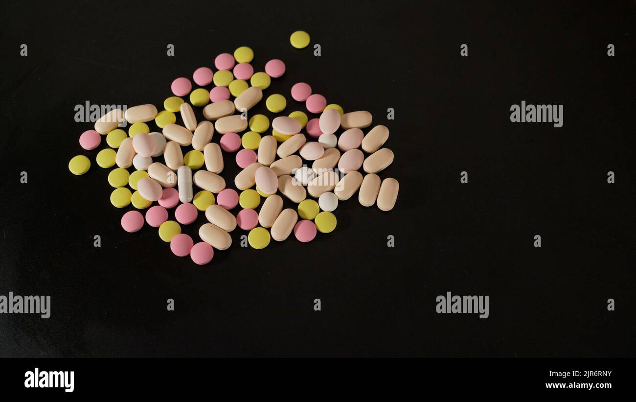Tablets of different sizes closeup. Medicines tablets, capsules, pills