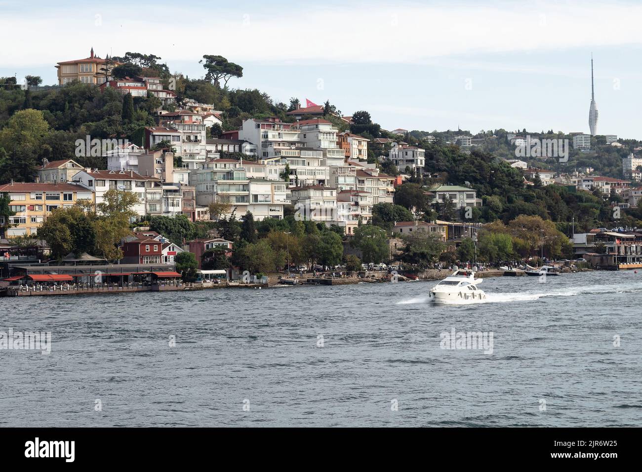 View of a yacht on Bosphorus and Cengelkoy area of Asian side in Istanbul. Stock Photo