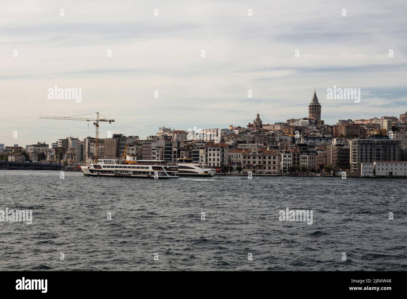 View of ferry boats on Golden Horn part of Bosphorus and Beyoglu district on European side of Istanbul. Galata tower is also in the view. Beautiful sc Stock Photo