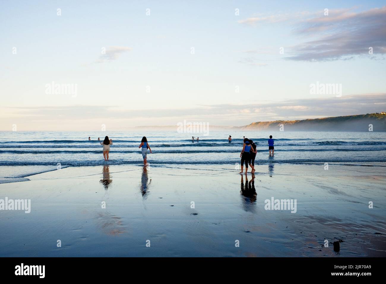 A group of teenagers in the sea on a summer evening Stock Photo