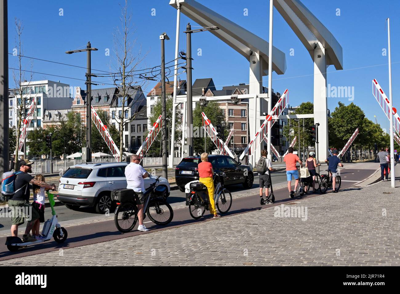 Antwerp, Belgium August 2022 Cyclists and cars waiting as the gates
