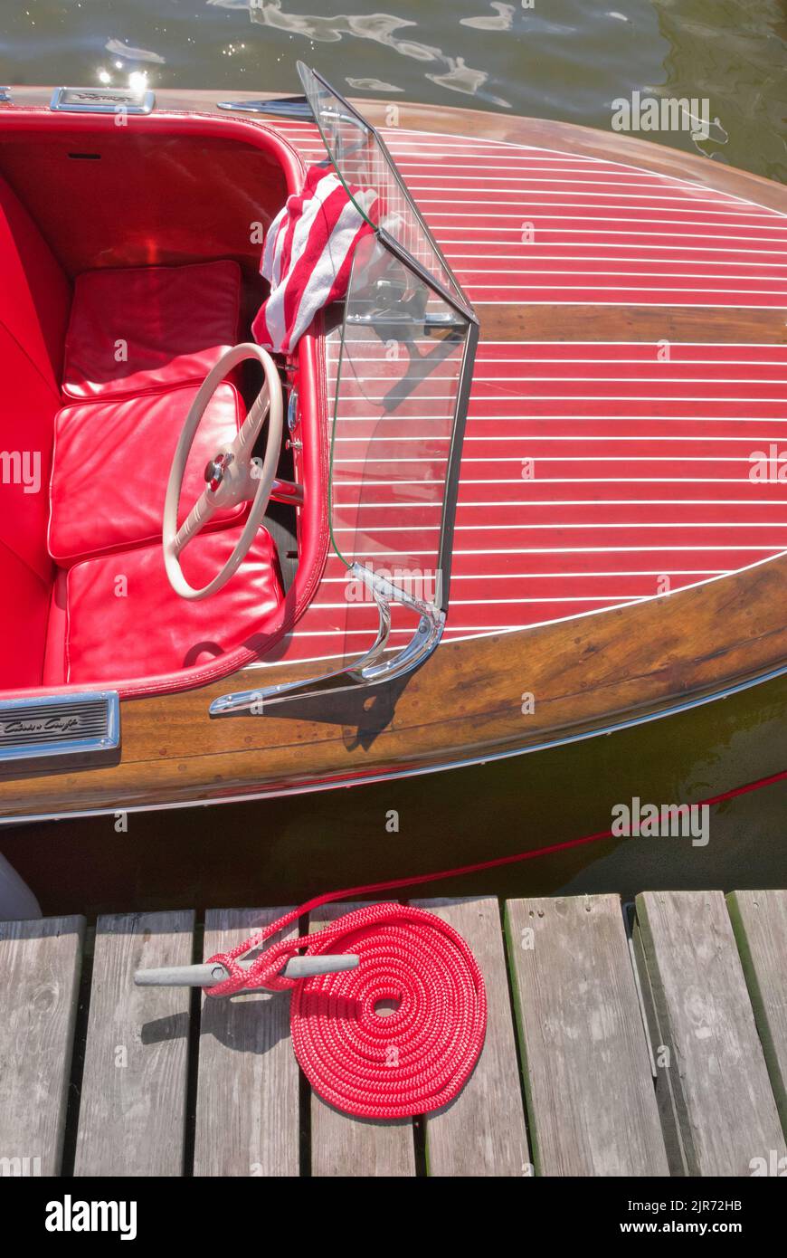 Essex, CT, USA - July 10, 2010: Vintage Chris Craft runabout wooden boat awaits judging dockside at the Mahogany Memories Wooden Boat Show Stock Photo