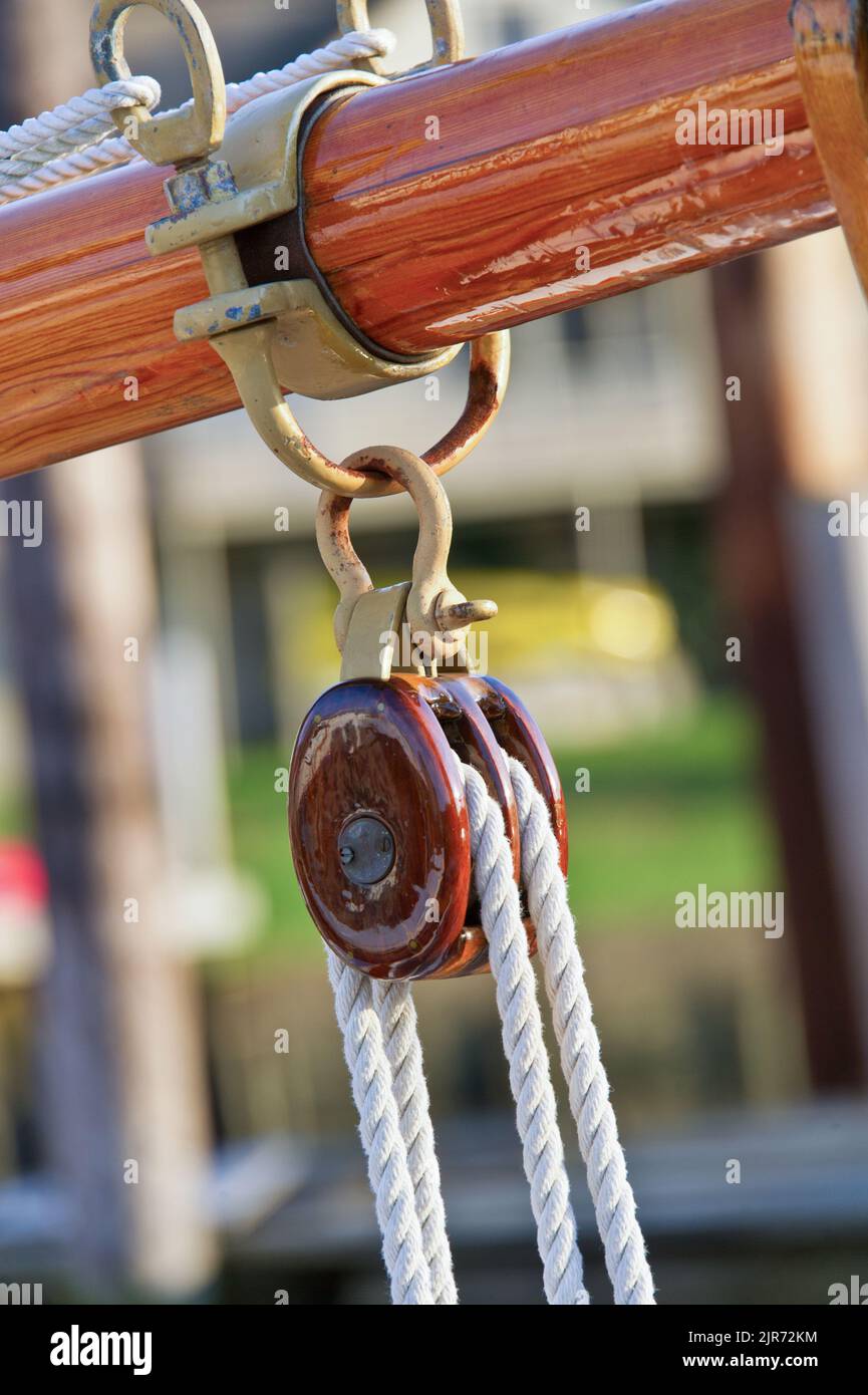 Twogang varnished wood pulley block on classic wood yacht Stock Photo