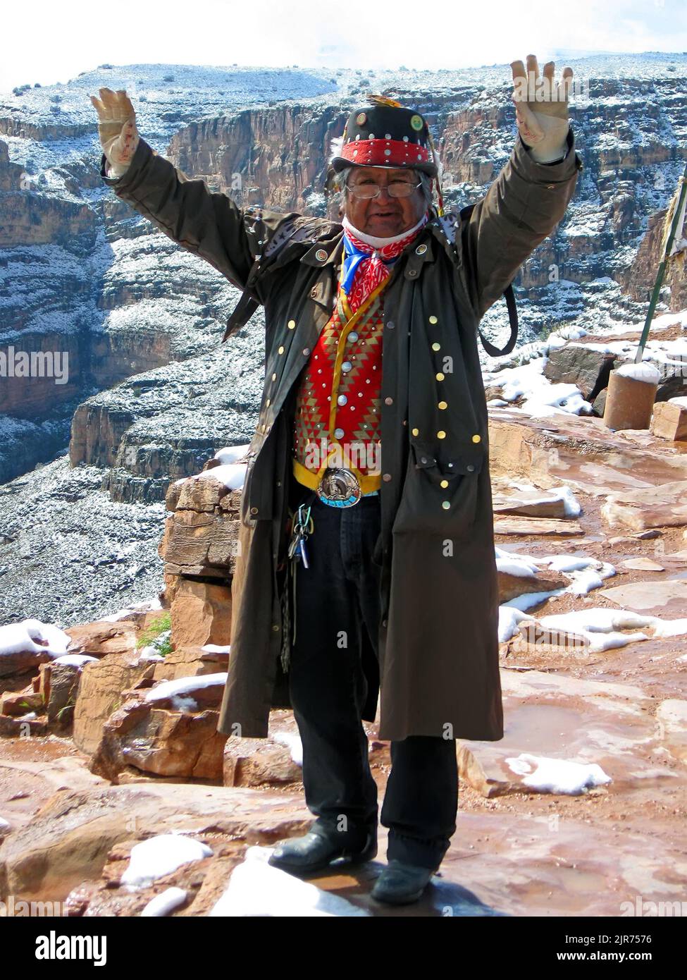 single indian in national suite and hat in Grand Canyon send welcome to visitors in Arizona, USA. Stock Photo