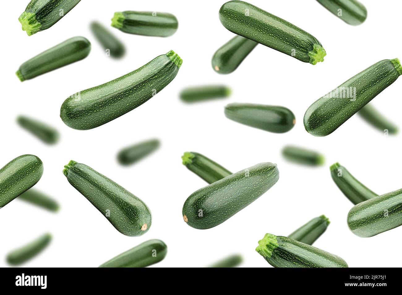 Falling zucchini isolated on white background, selective focus Stock