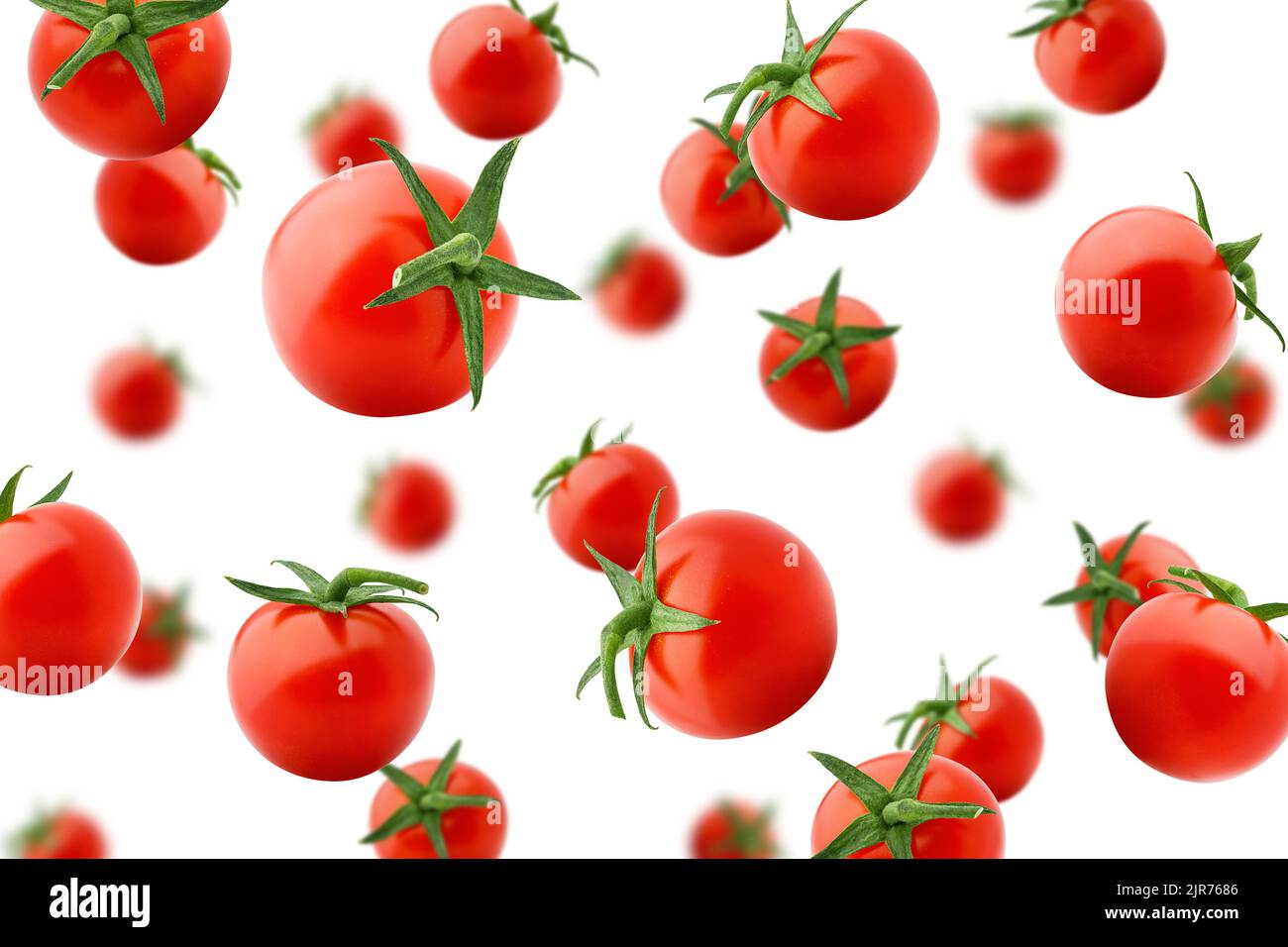 Falling tomato cherry isolated on white background, selective focus Stock Photo