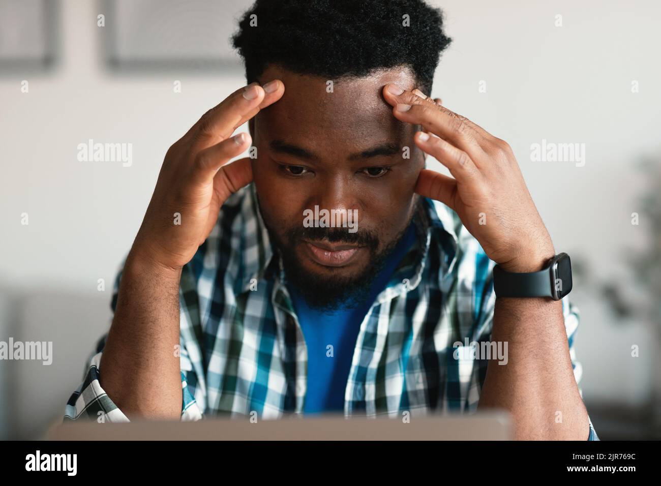 Thoughtful Black Guy Using Laptop Having Business Problems At Workplace Stock Photo