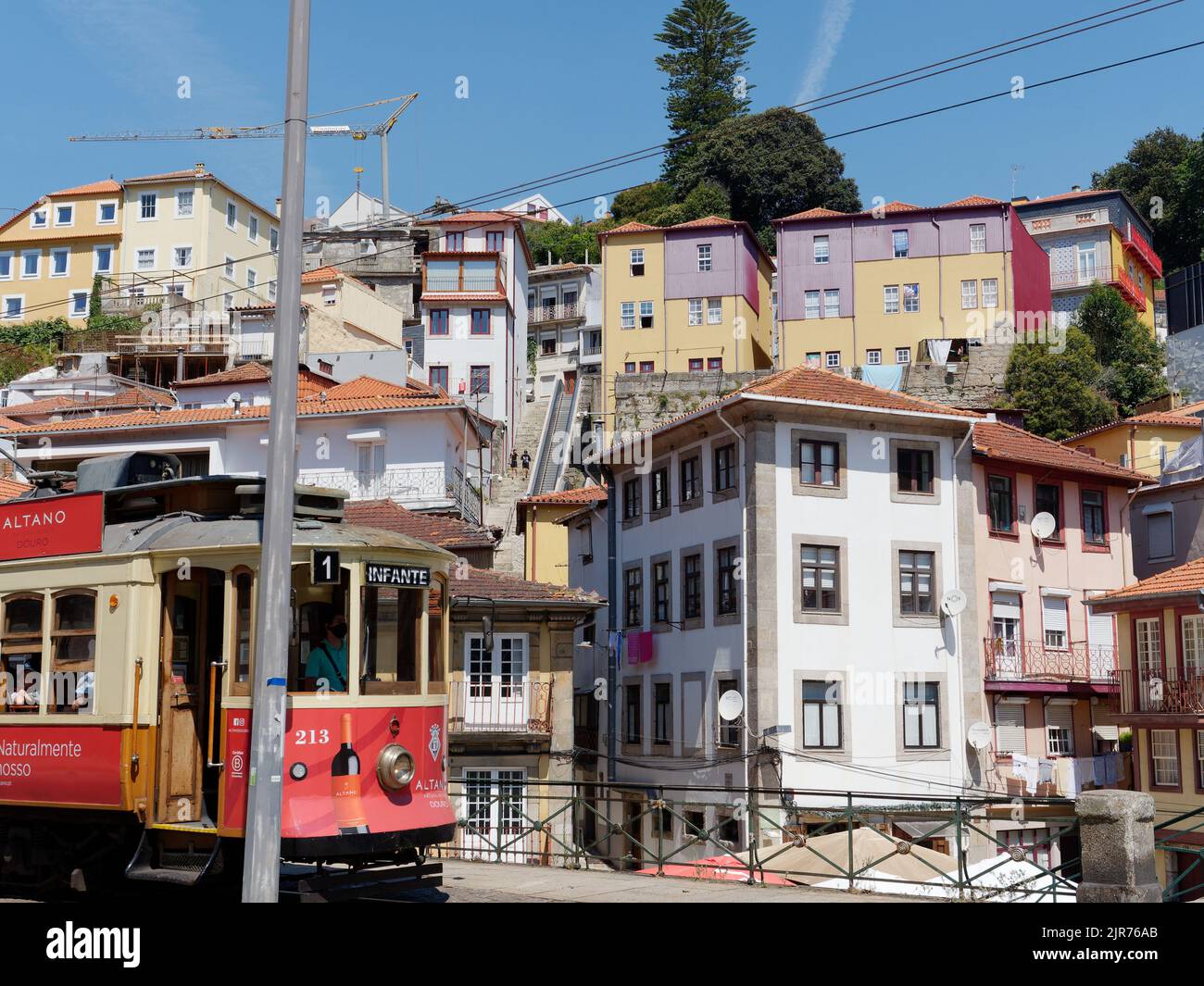 Traditioanl properties in Porto Portugal as a tram passes by. Stock Photo