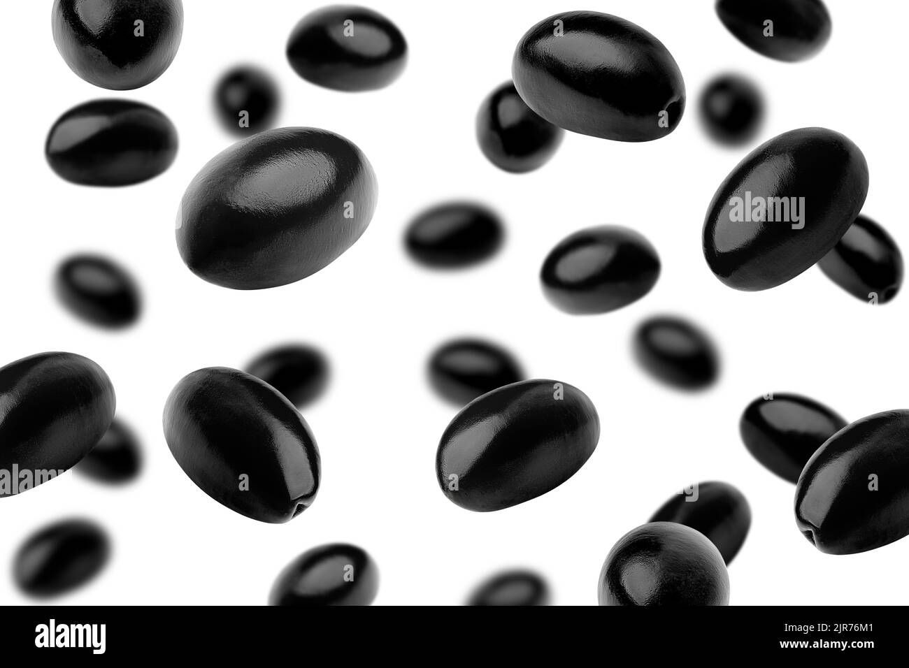 Falling black olive isolated on white background, selective focus Stock