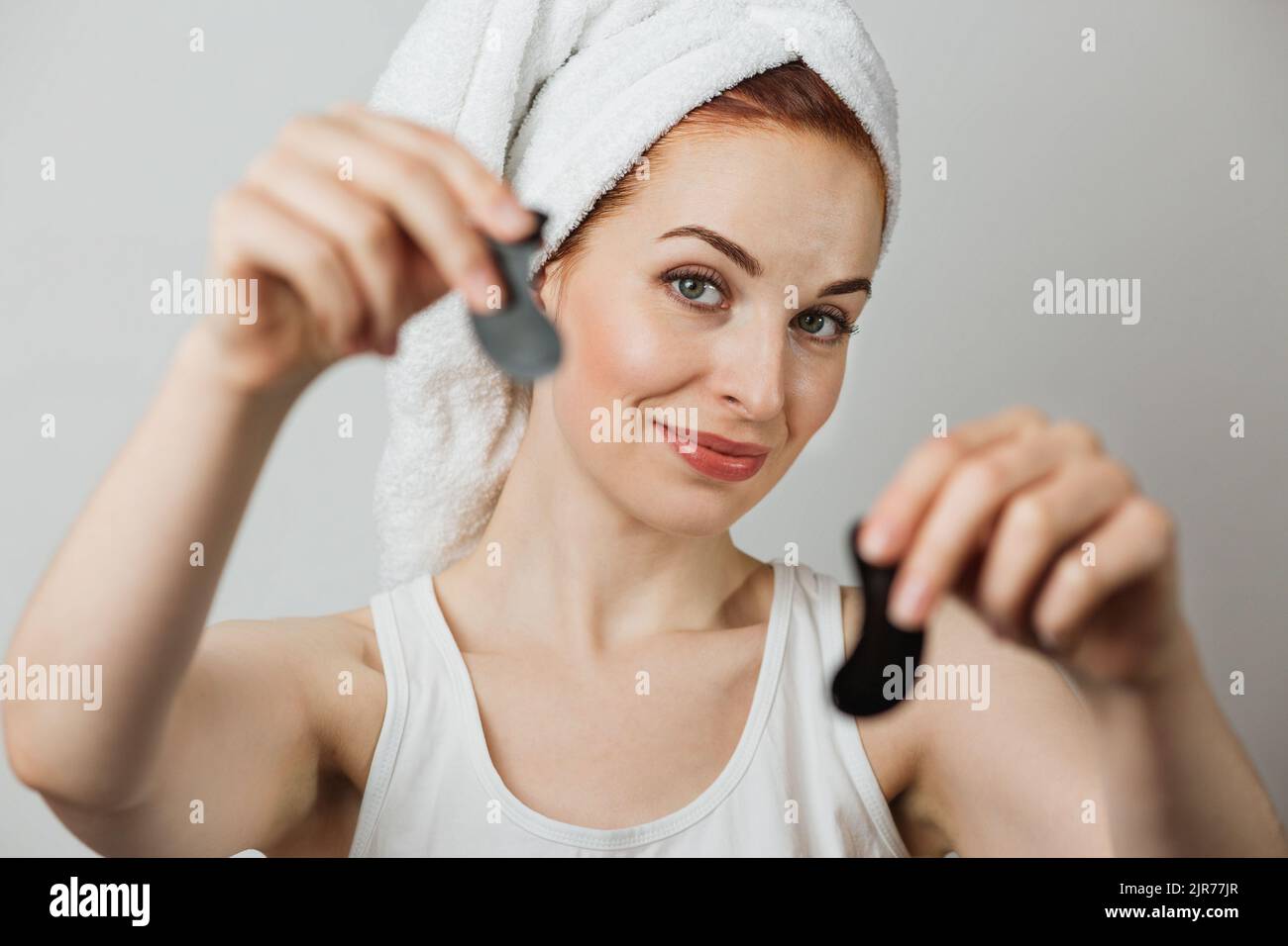 Portrait of pleasant caucasian young woman in towel with healthy skin ...