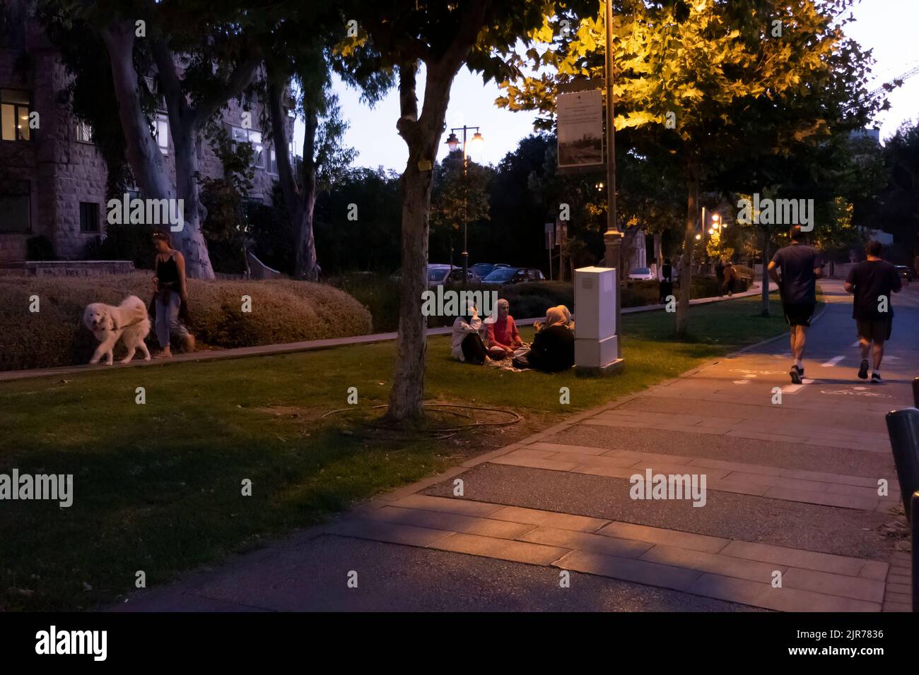 People stroll on the boardwalk of the Train Track Park or in Hebrew Park HaMesila which follows the route of the original Jaffa–Jerusalem railway from the Jerusalem Railway Station near the German Colony in west Jerusalem Israel Stock Photo