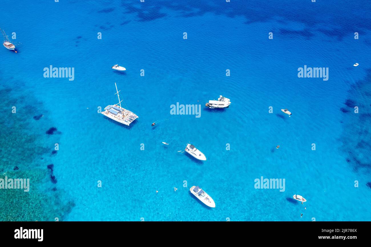 Drone aerial seascape luxury yachts moored in the coast unrecognised people swimming and relaxing. Summer vacations in the sea. Ayia Napa Cyprus Stock Photo