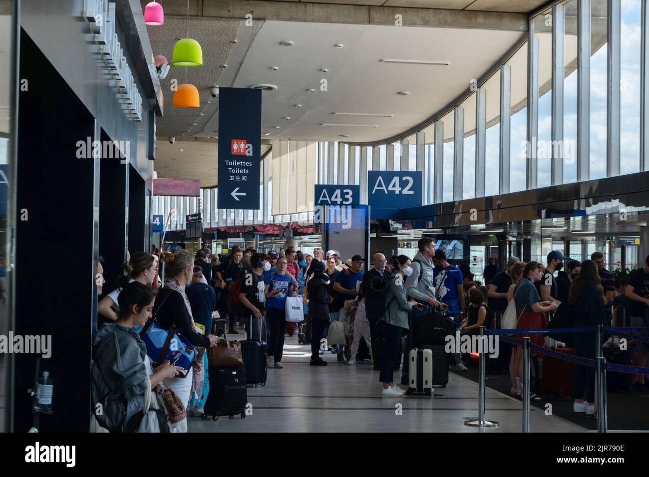 Roissy-en-France, France - 27 June 2022: Passengers waiting for their flights inside Roissy - Charles de Gaulle airport Stock Photo