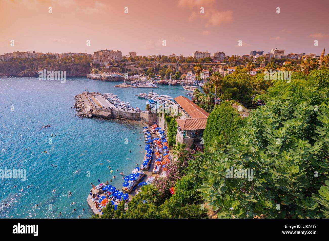 09 July 2022, Antalya, Turkey: Mermerli beach and old town Antalya port at sunset time Stock Photo