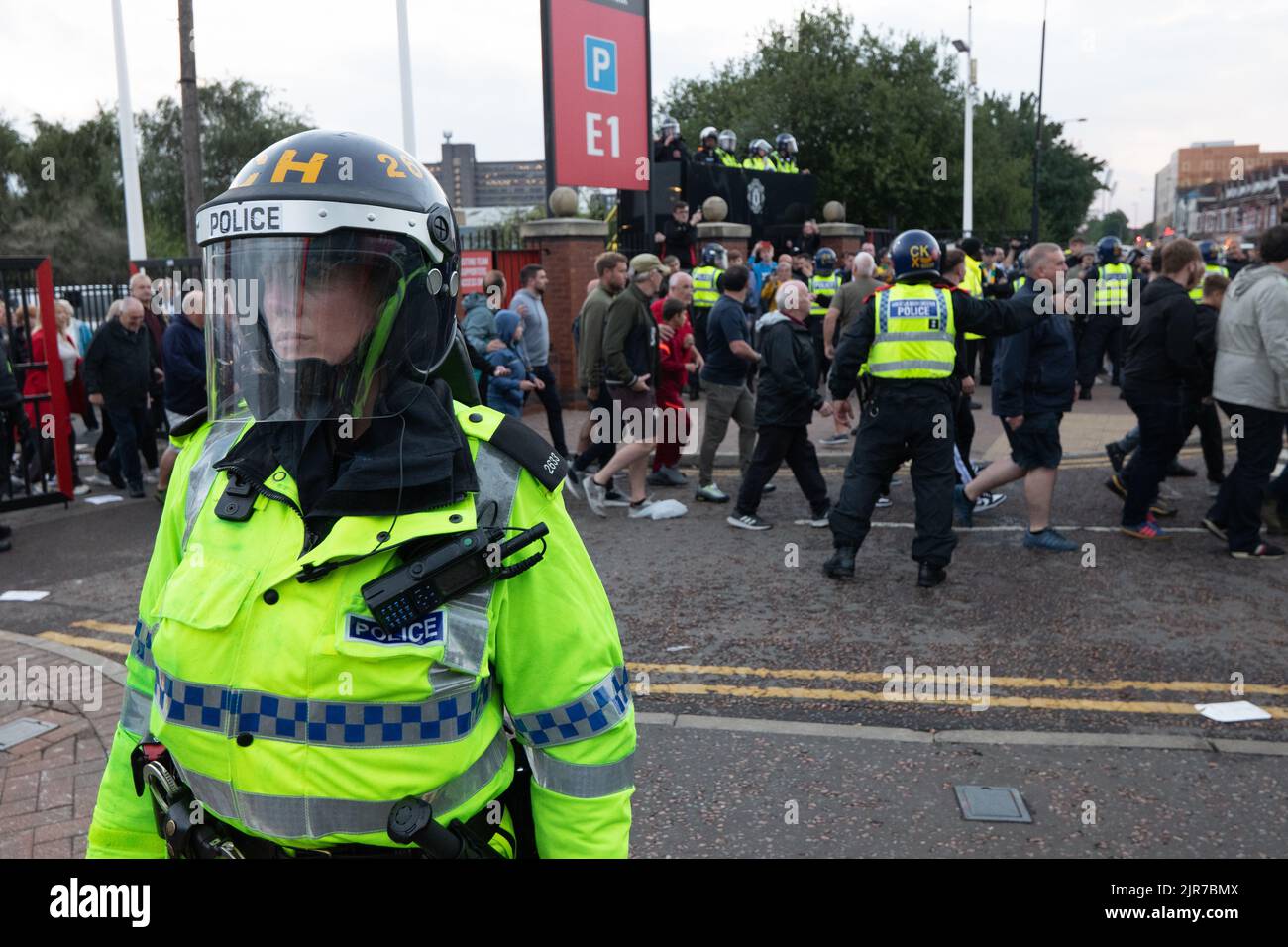 Manchester, UK. 22nd Aug, 2022. Liverpool fans are escorted past Man Utd  fans who were protesting ahead of Liverpool game in Old Trafford. Protests started at the Tollgate pub in Old Trafford and proceeded to the ground. Manchester United supporters are urging the club's owners,the Glazer family to sell the club immediately, after nine years and counting without a Premier League title. The American family have been unpopular figures at Old Trafford since Malcolm Glazer, who died in 2014, bought shares in the club in September 2003. Credit: GaryRobertsphotography/Alamy Live News Stock Photo