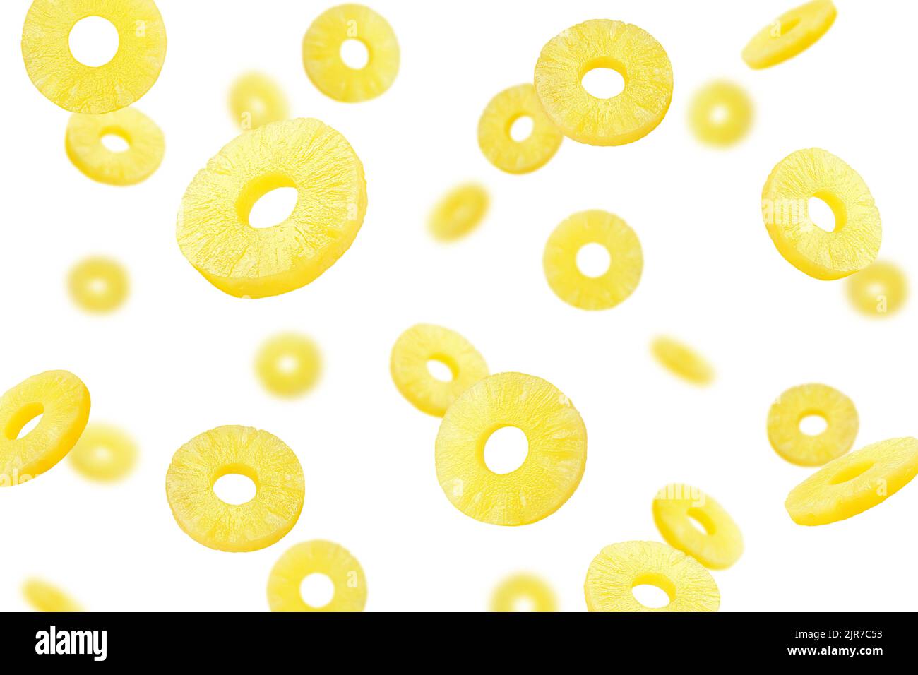 Falling pineapple slice, ring, isolated on white background, selective focus Stock Photo