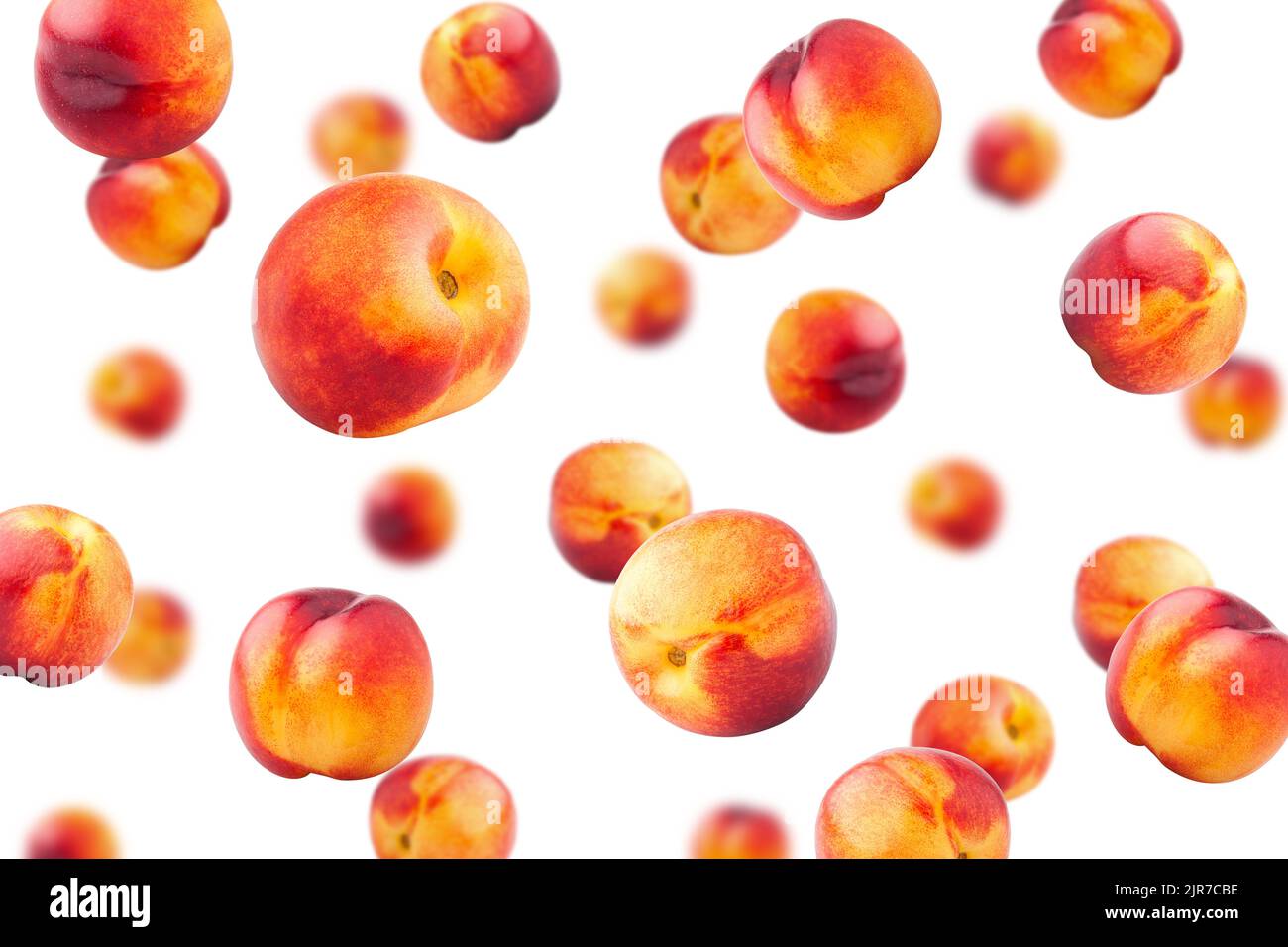 Falling Nectarine or peach isolated on white background, selective focus Stock Photo
