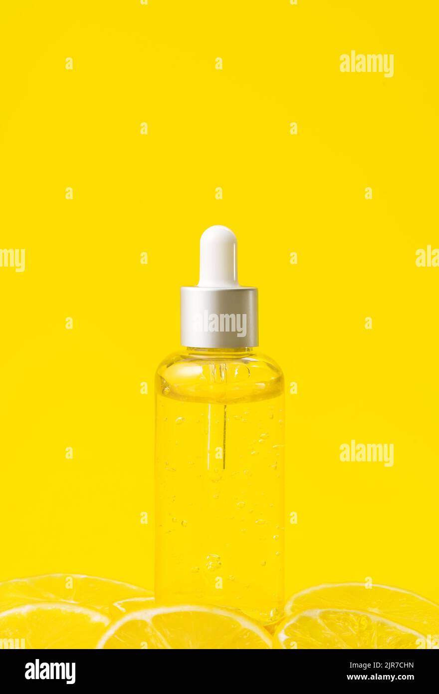 Vitamin C formula ampoule. Serum in transparent bottle with lemon on