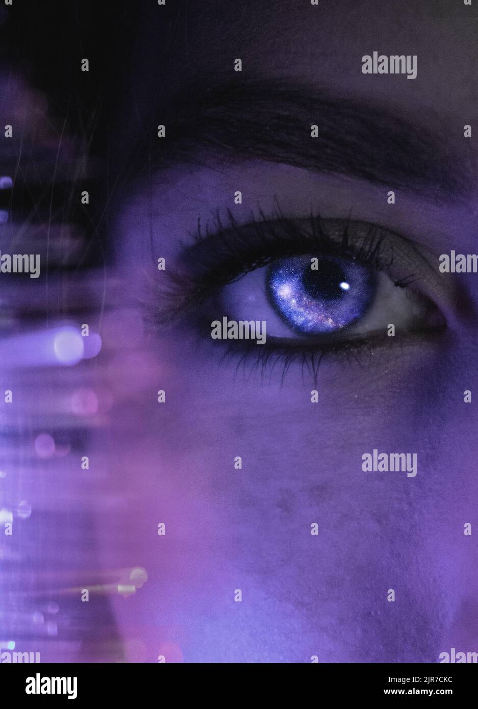 Female looking at the camera with eyes reflecting the galaxy, universe