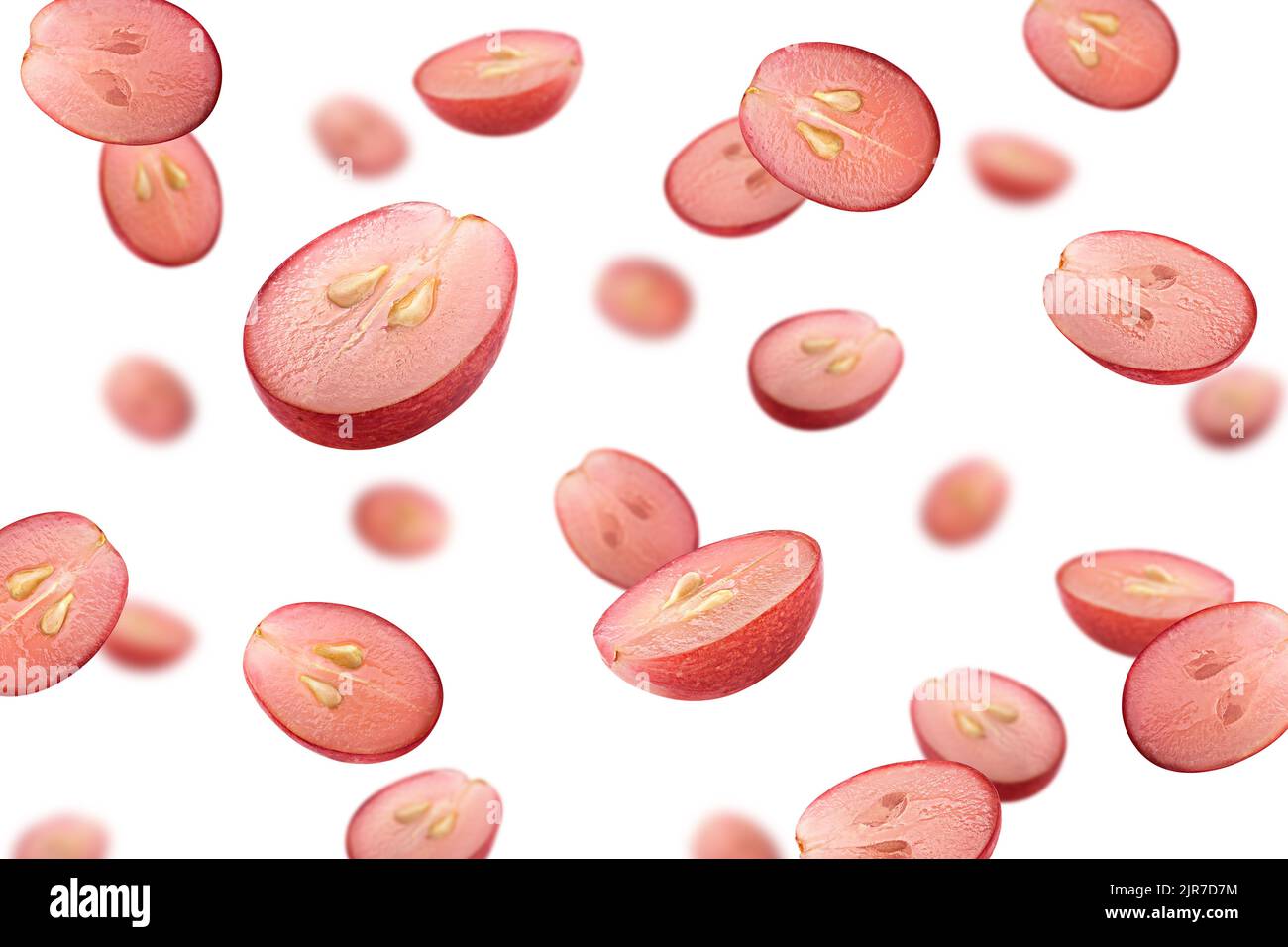 Falling red grape, isolated on white background, selective focus Stock Photo