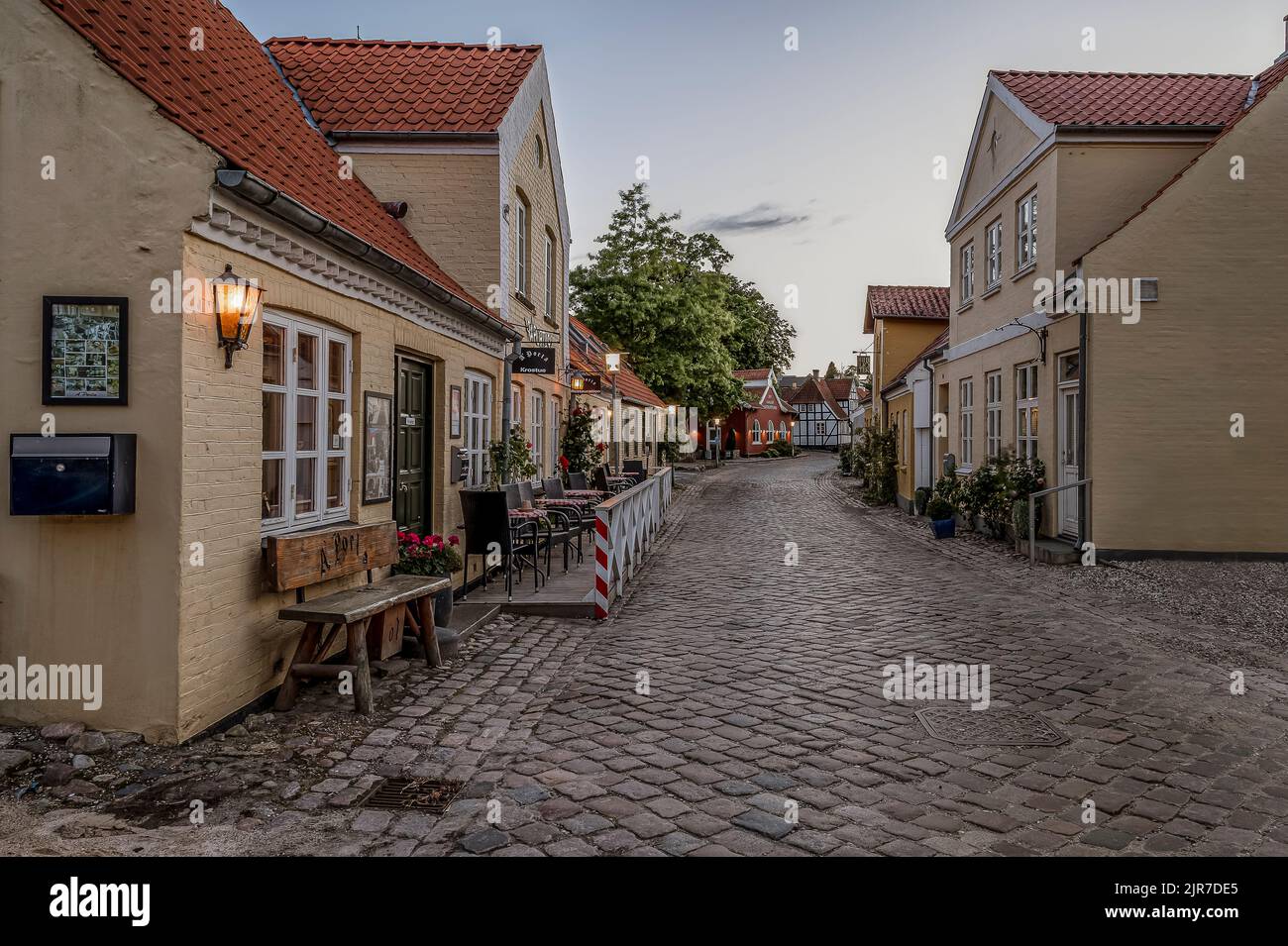 restaurant with roses in the soft evening light in the danish town Mariager, Denmark, August 5, 2022 Stock Photo