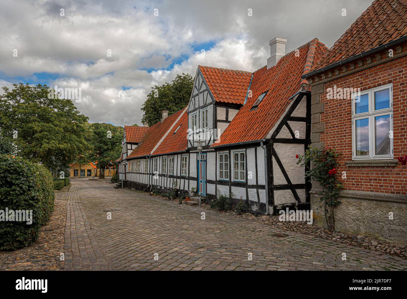 white and black half-timbered picturesque house on a cobbled street in the dansih town Mariager, Denmark, August 6, 2022 Stock Photo