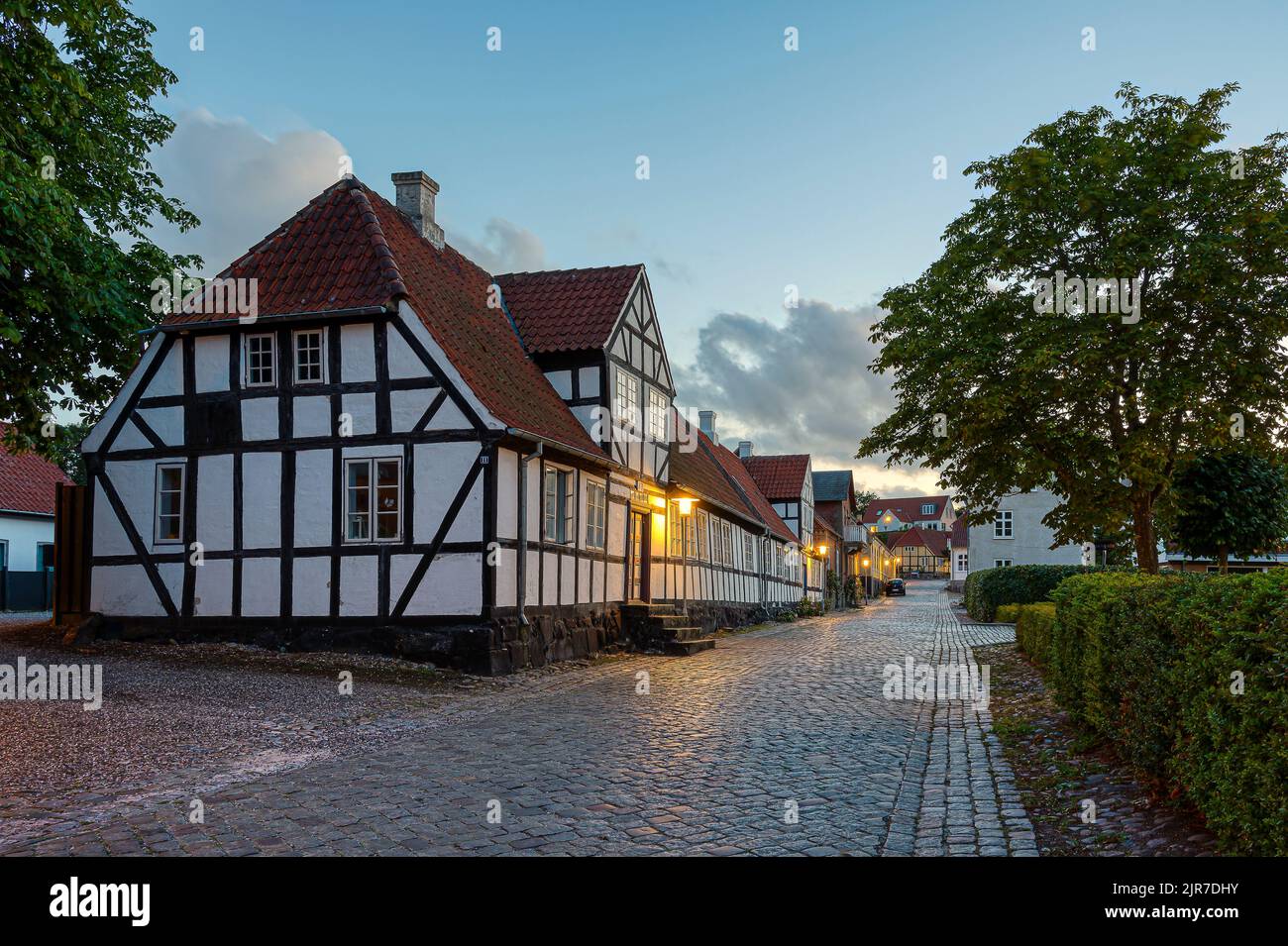 street view of a big half-timbered house in black and white in the evening dusk, Mariager, August 6, 2022 Stock Photo