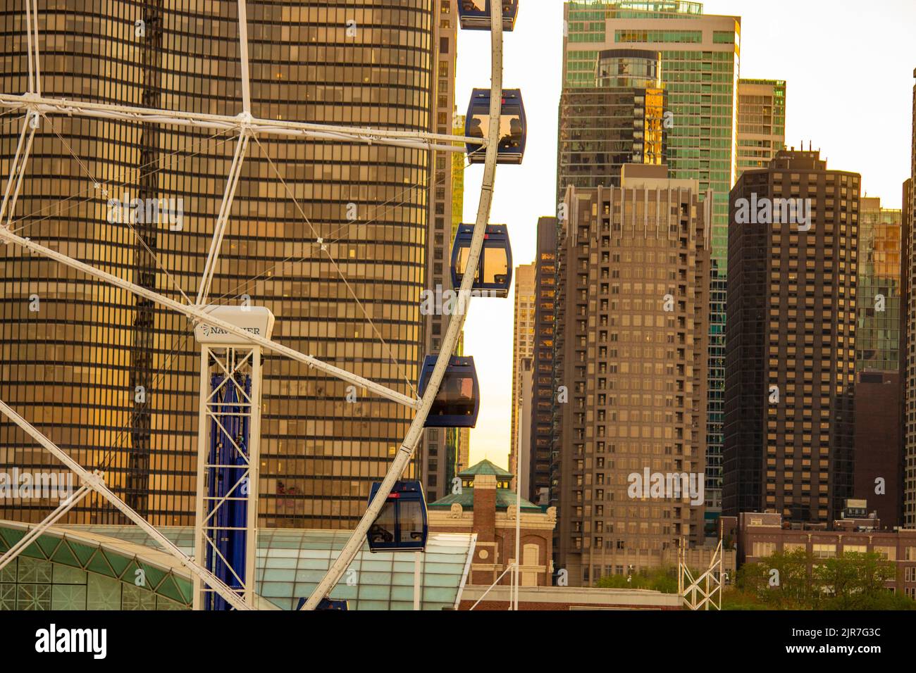 A Ferris wheel with city skyline against sunset at Navy Pier,Chicago Stock Photo