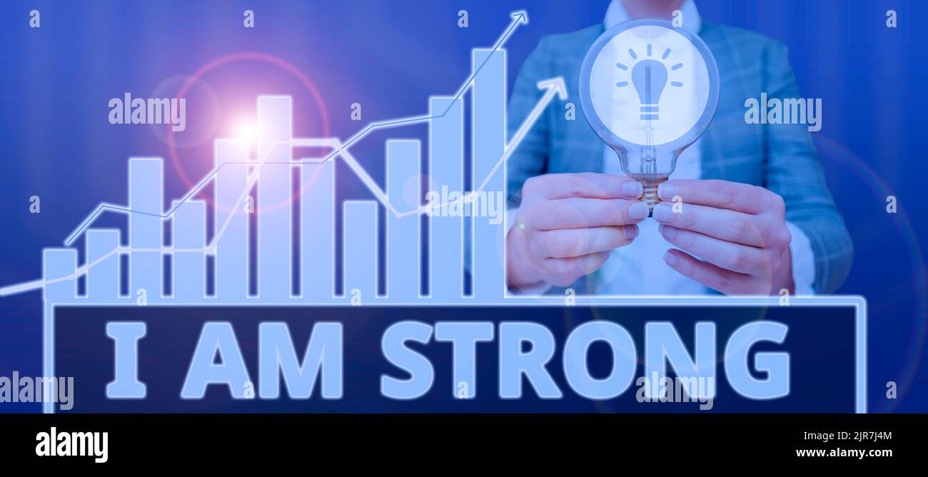 Hand writing sign I Am Strong. Internet Concept Have great strength being healthy powerful achieving everything Woman With Light Bulb Presenting Stock Photo