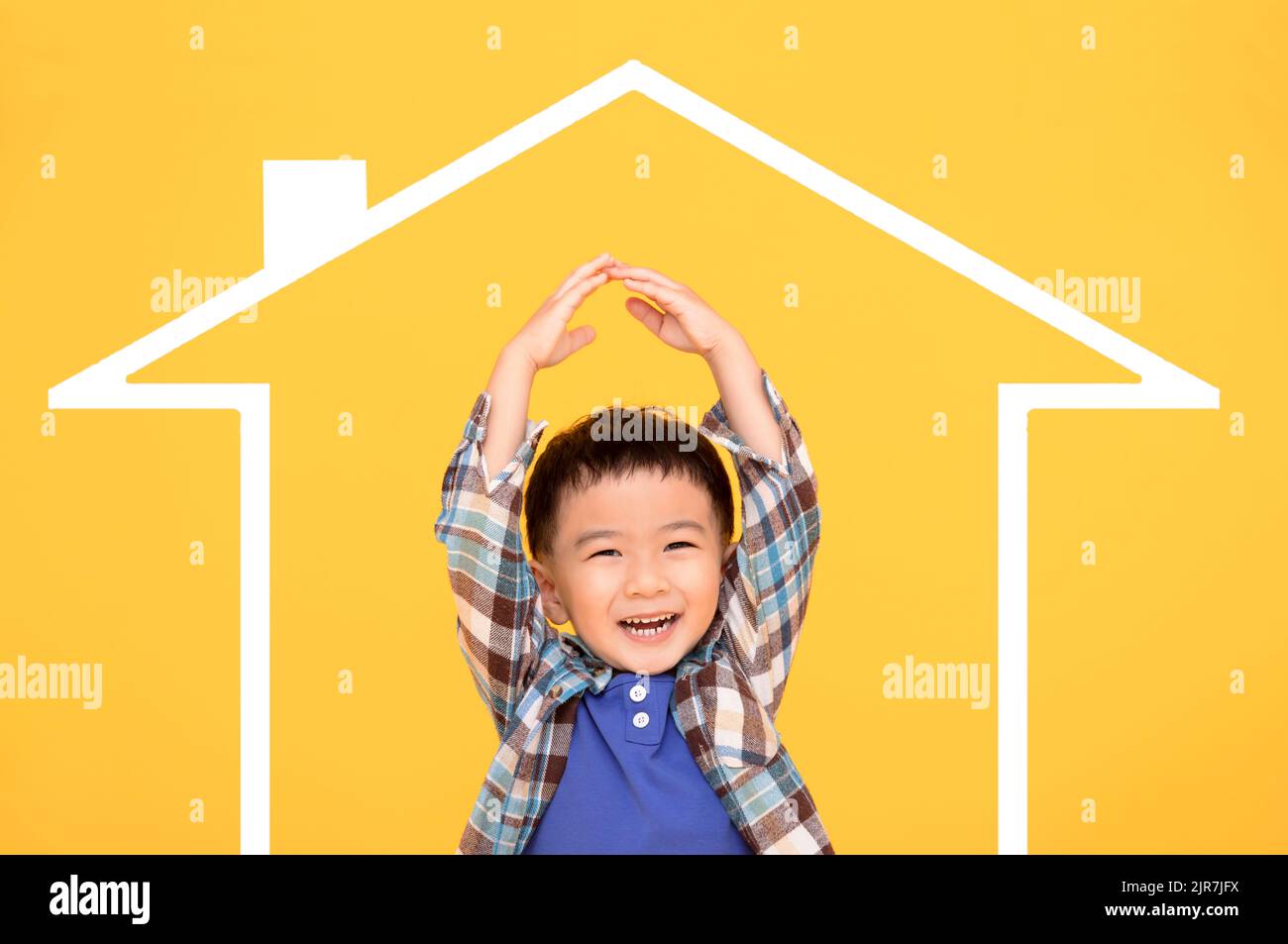 Happy asian kid making symbolic roof of hands above Stock Photo