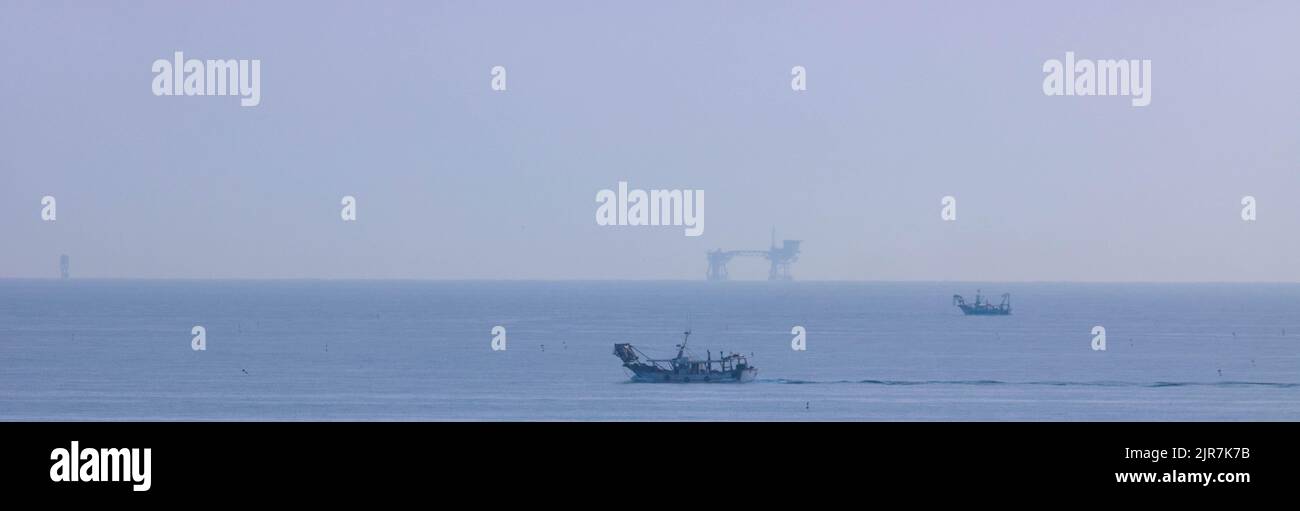 View of the Ligurian sea with boats and oil platform, Rimini, Italy. High quality photo Stock Photo