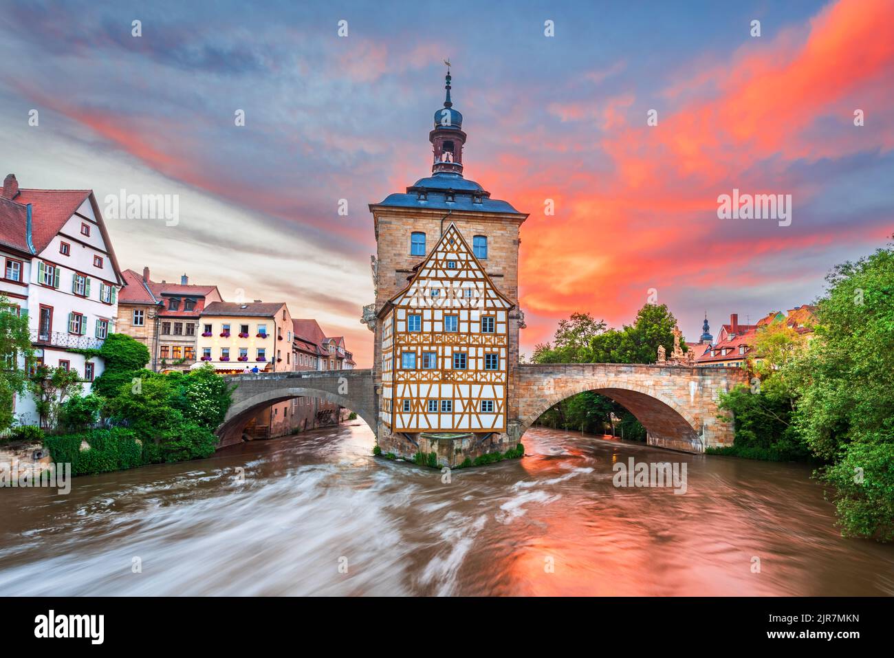 Bamberg, Germany. Amazing sunset with the old small city in Franconia, Bavaria.  Regnitz River sky reflection. Stock Photo