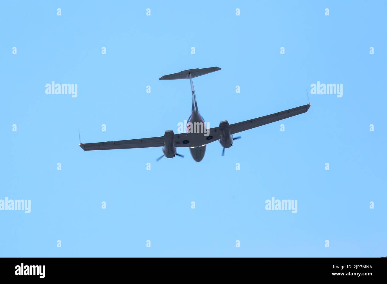 twinengine light aircraft flying in the sky Stock Photo Alamy