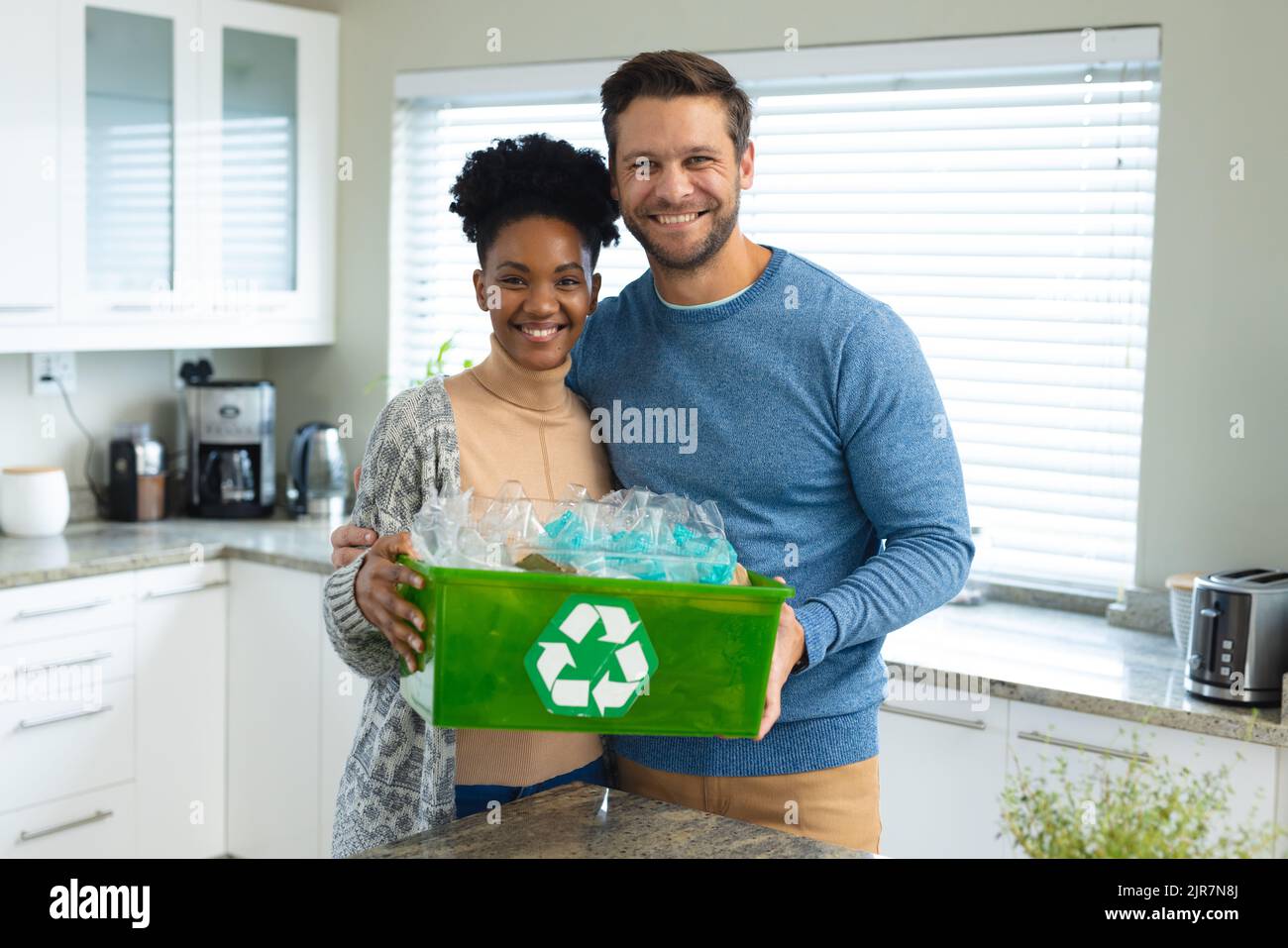 Image of happy diverse couple with recycling bin Stock Photo