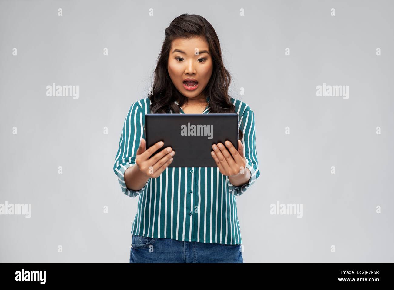surprised asian woman using tablet computer Stock Photo