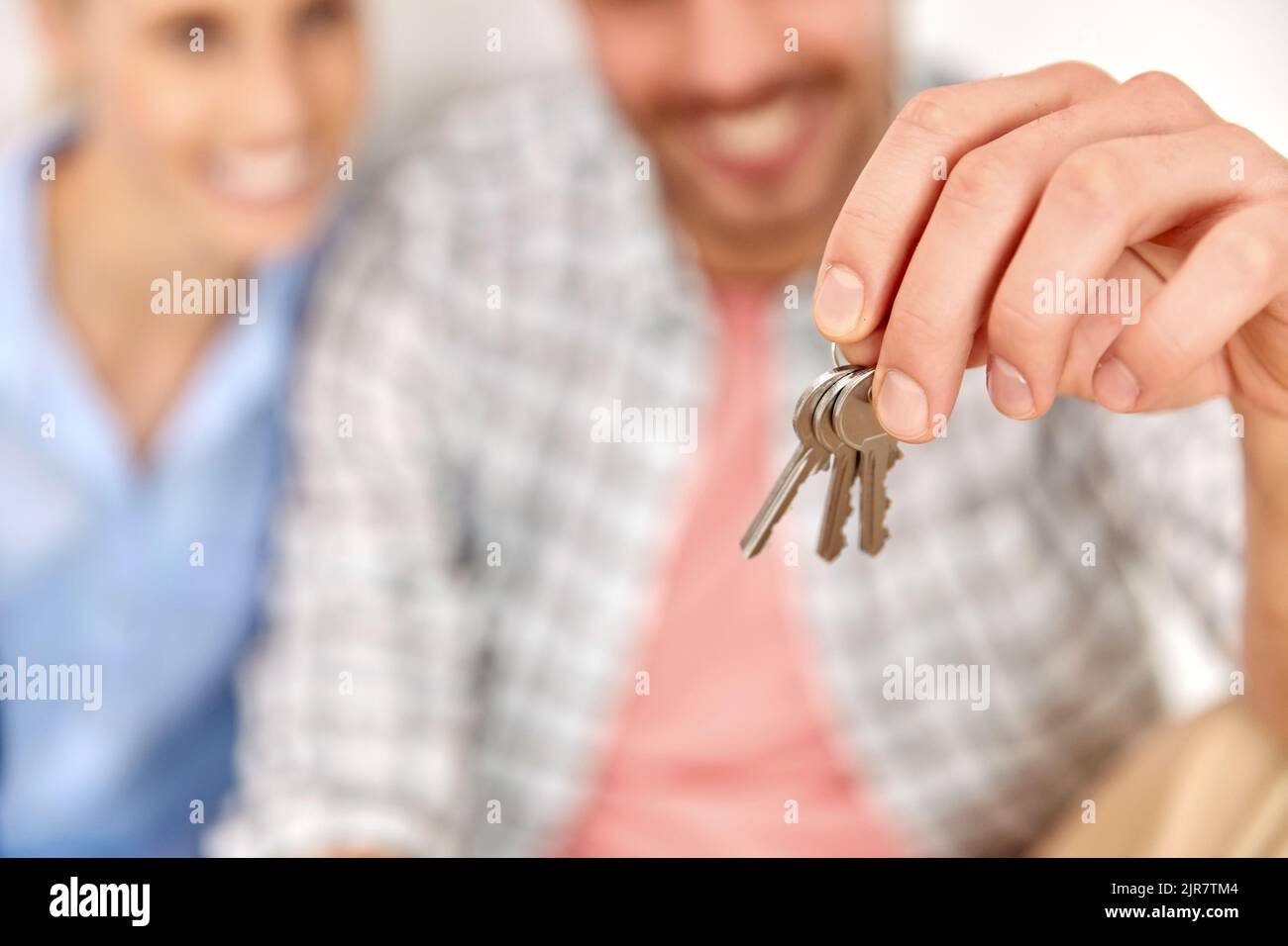 happy couple with key and boxes moving to new home Stock Photo - Alamy
