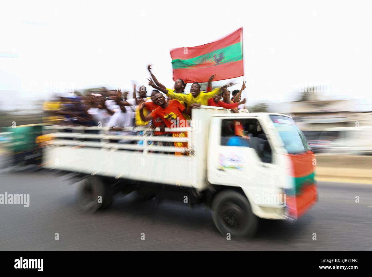 Supporters of Angola's main opposition party UNITA, ride at the back of a truck to attend the party's final rally at Cazenga, outside the capital Luanda in Angola, August 22, 2022.REUTERS/Siphiwe Sibeko Stock Photo