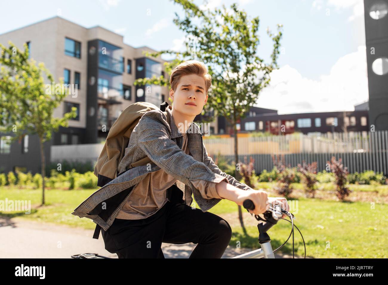 young man riding bicycle on city street Stock Photo