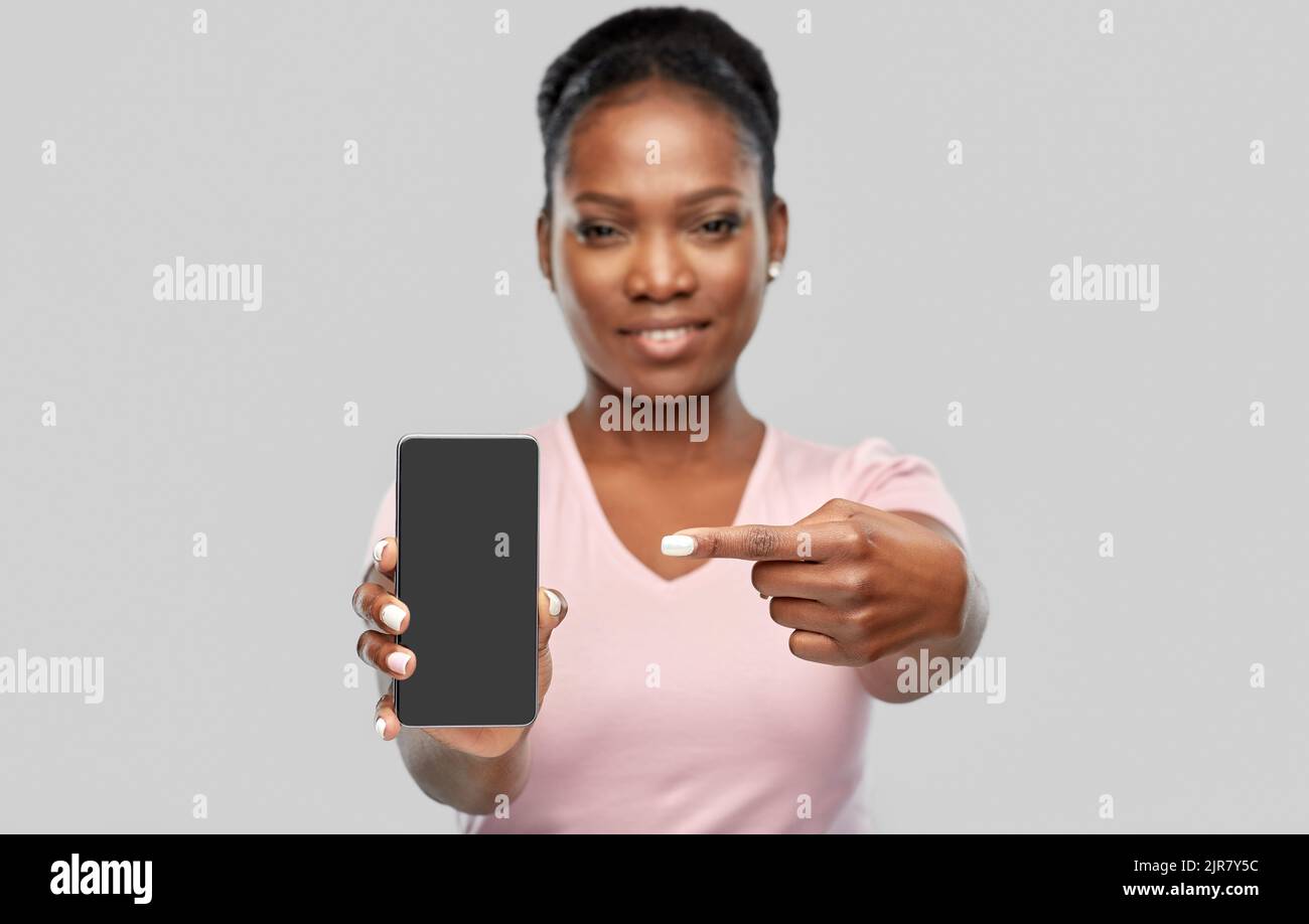 happy african american woman showing smartphone Stock Photo - Alamy