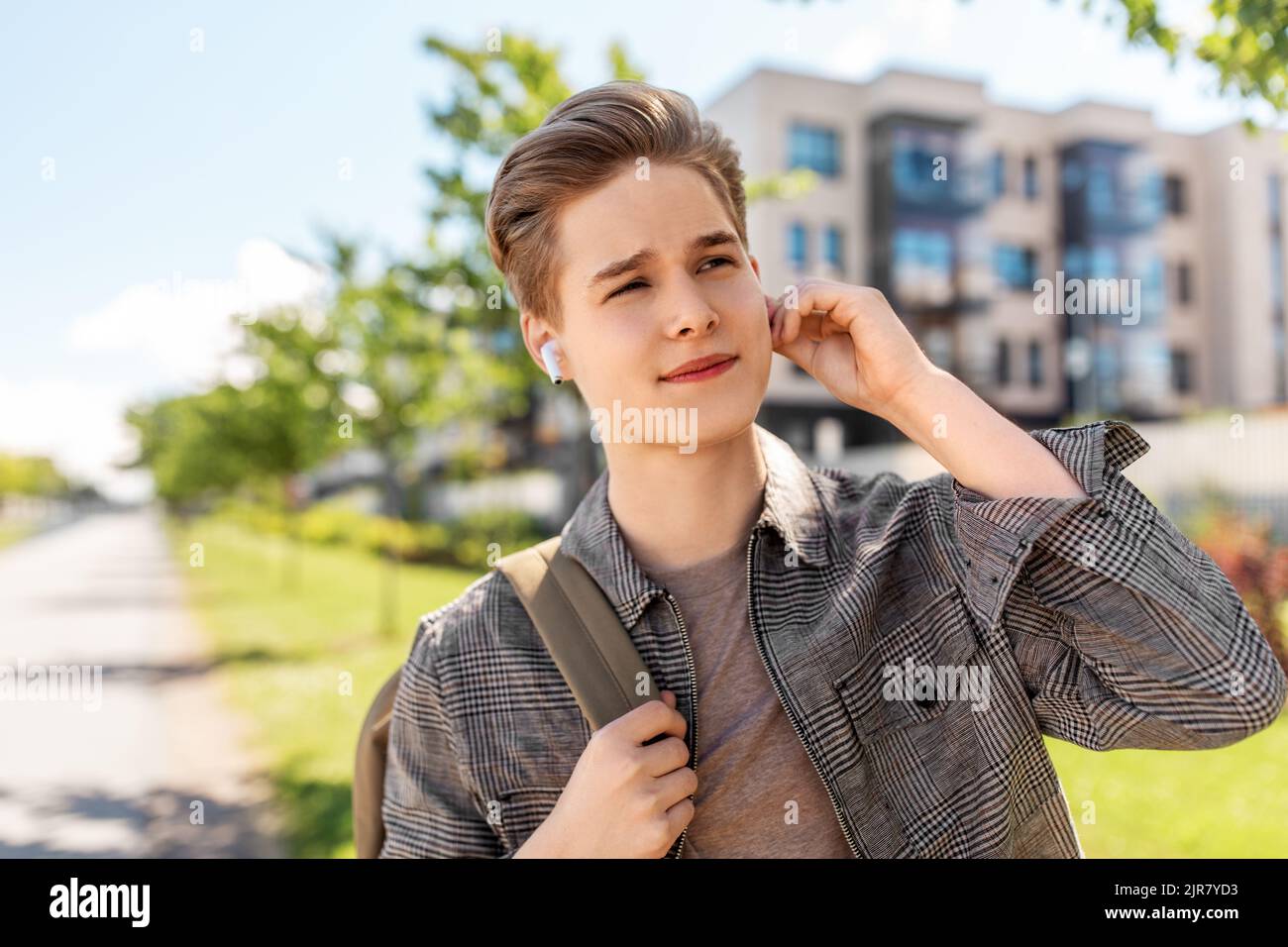 young man with earphones and backpack in city Stock Photo