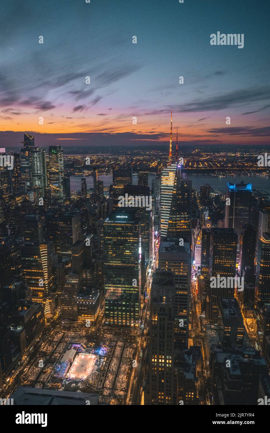 The New York city skyline at sunset with the lights shining bright ...