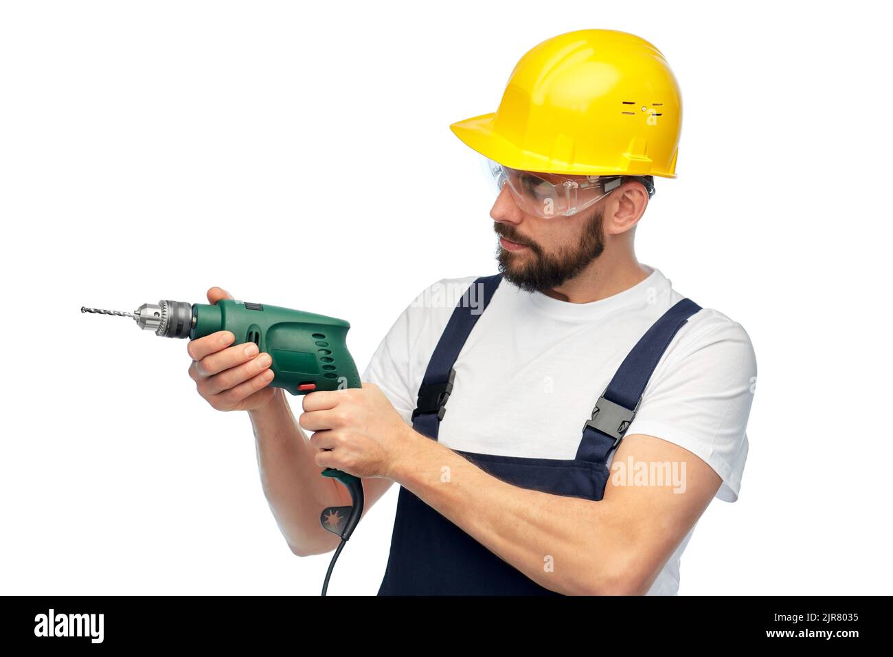 male worker or builder in helmet with drill Stock Photo