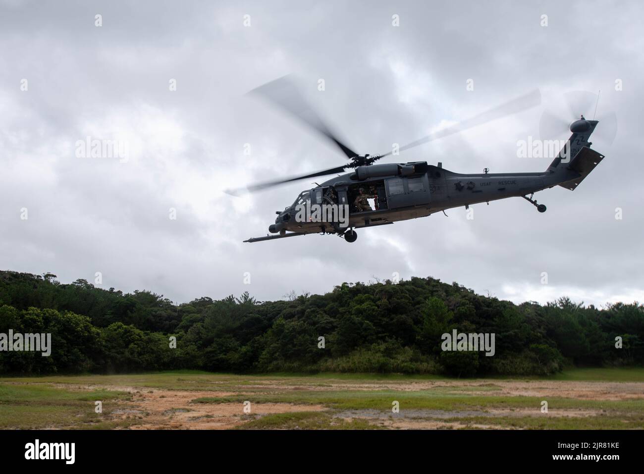 An HH-60 Pave Hawk lands in a clearing during a training rescue exercise at Kadena Air Base, Japan, Aug. 17, 2022. The 33rd RQS train, plan and execute to ensure they are prepared to execute rescue operations when called upon. (U.S. Air Force photo by Airman 1st Class Tylir Meyer) Stock Photo