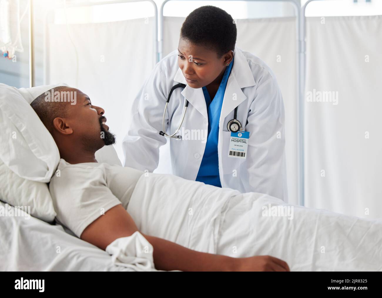 Consulting, hospital plan and healthcare with a sick patient talking to a doctor after cancer diagnosis. Caring health care professional support and Stock Photo