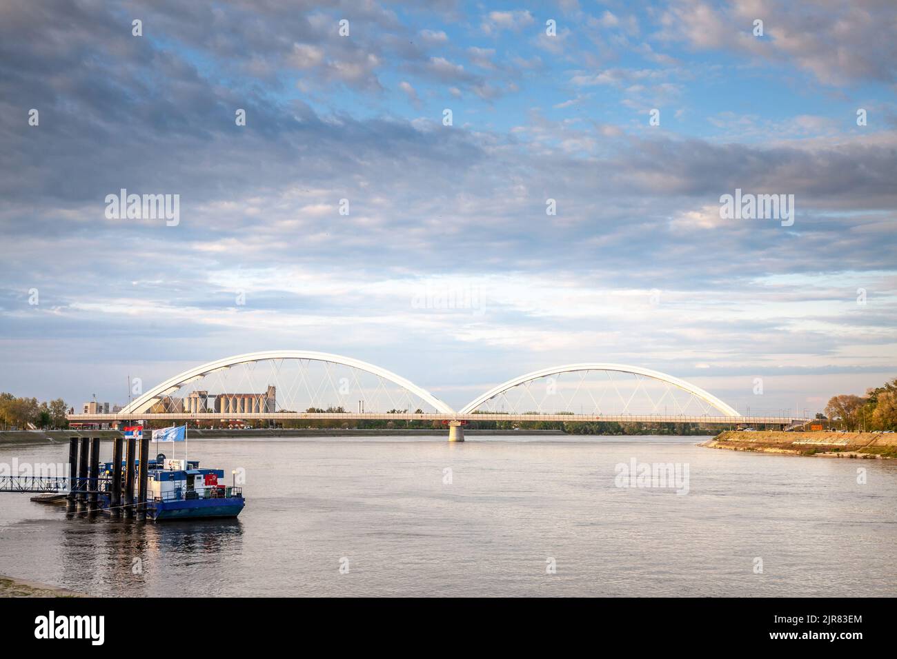 Picture of the Zezeljev most bridge in novi sad during a sunny afternoon. Žeželj Bridge is a tied-arch bridge on Danube river in Novi Sad, Vojvodina, Stock Photo