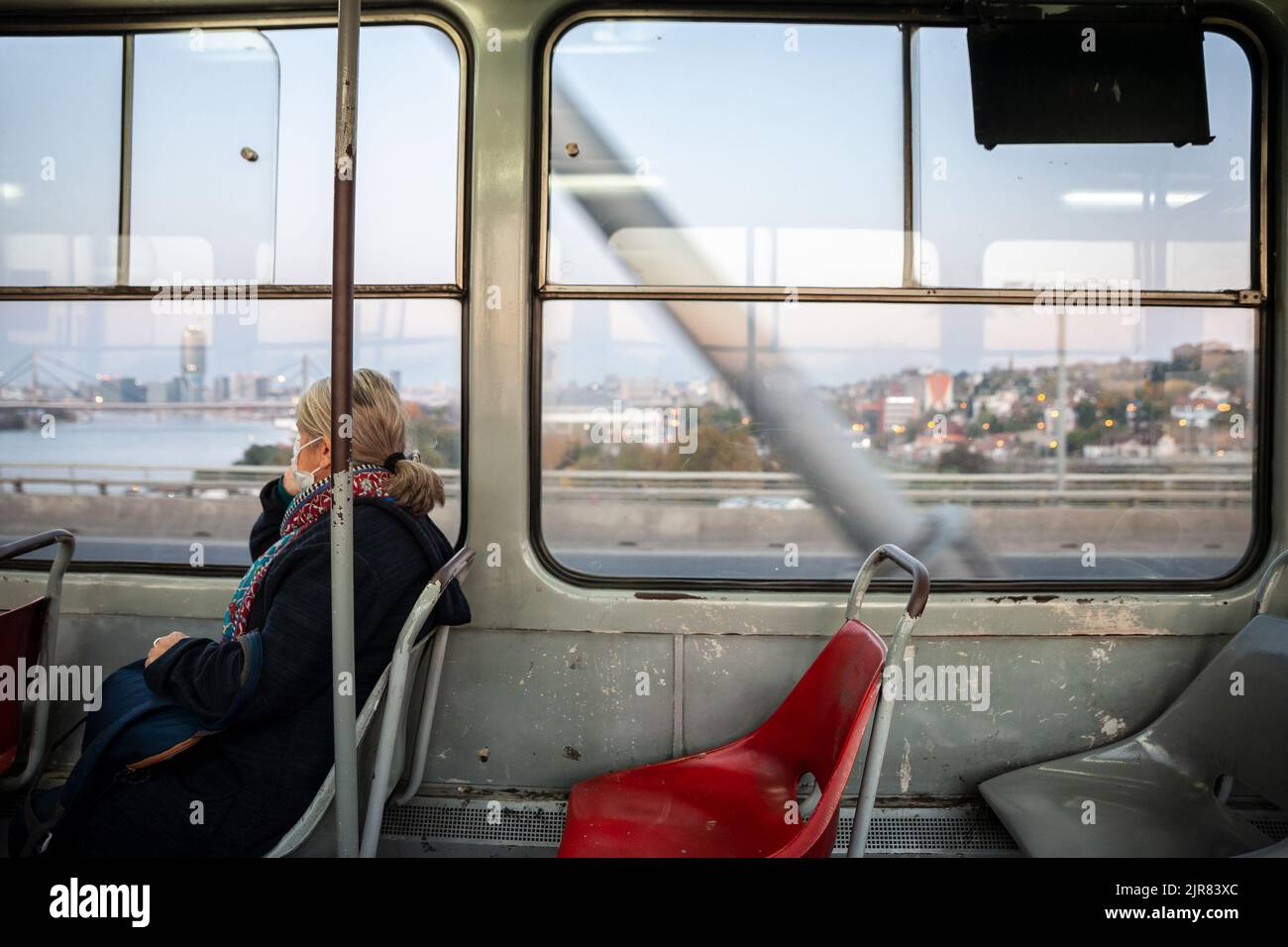 Picture of plastic seats in a belgrade tramway car with a speed blur in background, in Belgrade, Serbia, with an old woman sat. The Belgrade tram syst Stock Photo