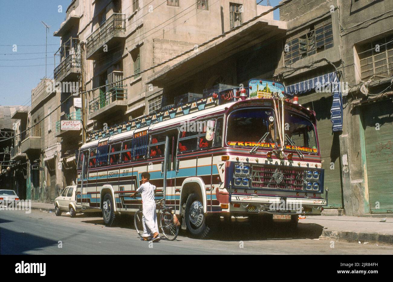 Street scene in Damascus, 1985. The gaudily-decorated bus evokes the era of overland travel across western Asia Stock Photo