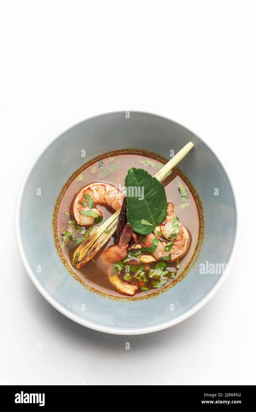 thai tom yam kung spicy curry soup with prawns on white background