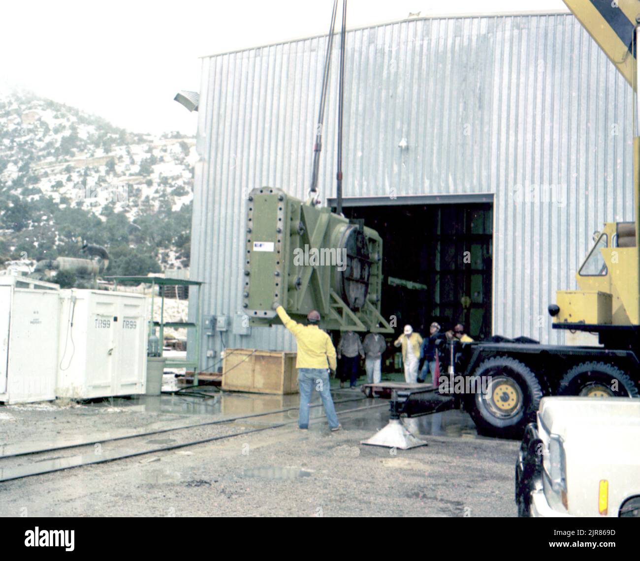 A800140 U12N MINERS IRON DAC UNLOADING TEISHER(Project Engineer) JAN 7 80EG&G/NTS PHOTO LAB Publication Date: 1/7/1980  CRANES; DAC UNLOADING; DACS; EQUIPMENT & INSTRUMENTS; INSTRUMENTS & EQUIPMENT; MINERS IRON; MINERS, IRON ORE; MINES (WEAPON); N-TUNNEL; NEVADA; NEVADA TEST SITE; NTS; NUCLEAR ENERGY TECHNOLOGY; TEST SITES; UGT; UNDERGROUND TESTING; WAREHOUSES  historical images. 1972 - 2012. Department of Energy. National Nuclear Security Administration. Photographs Related to Nuclear Weapons Testing at the Nevada Test Site. Stock Photo